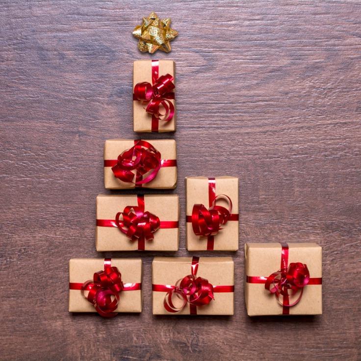 Creative concept with gift boxes christmas tree of gifts on a wooden